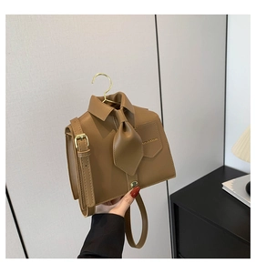Close-up of brown PU leather tote with unique shirt collar design and golden hooks