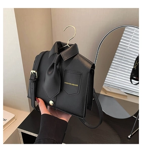 Detail of shirt-shaped black crossbody bag with faux collar and fashion print