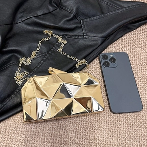 Golden geometric hard shell evening bag with metallic finish and thin chain strap