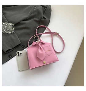 Macro shot of pink shirt-shaped tote bag detail with golden Fashion Bags lettering