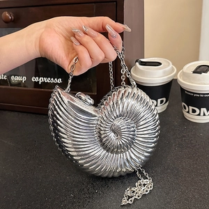 Chic silver seashell-shaped metal clutch bag with chain strap and shiny mirror finish