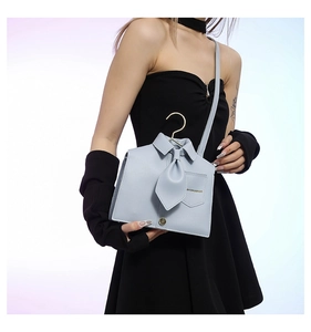 Detail of light blue PU leather shirt-shaped crossbody bag with tie and hanger handle