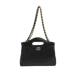 Women's black quilted tote bag with golden double ring logo and chain shoulder strap