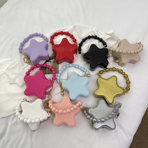Star-shaped mini crossbody bags with bead handles and gold chains in multiple colors