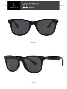 Macro detail of black pilot sunglasses with red wing decorations and dark grey lenses