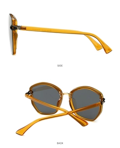Detail view of amber transparent TR sunglasses frame with side and back hinge angles