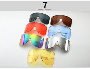 Detail of oversized shield sunglasses with gold stud trim and assorted lens colors
