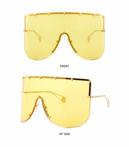 Detail of yellow mask sunglasses with gold star rivets and slim metal temples