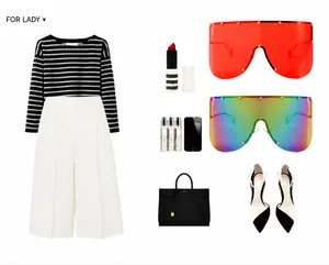Flat lay of shield sunglasses paired with monochrome outfit and black leather handbag