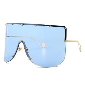 Oversized blue mask sunglasses with gold star rivets and slim metal temples for street style