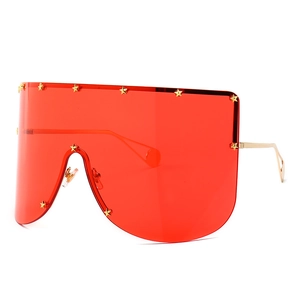 Futuristic shield sunglasses with red lenses and gold star rivets on a metal frame
