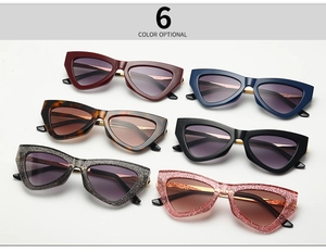 Flat lay of trendy narrow cat-eye sunglasses in six stylish colors and textures