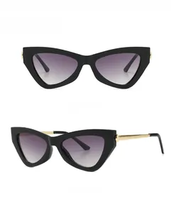 Detail of vintage cat-eye sunglasses with thick black frames and gold metal temples