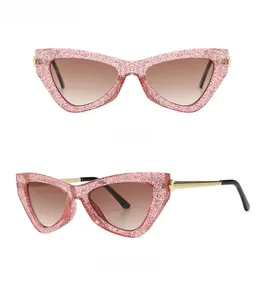 Detailed front and side views of pink translucent cat eye sunglasses with gold temples