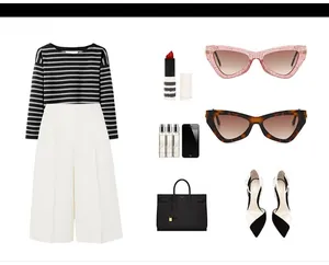 Flat lay of cat-eye sunglasses paired with striped sweater and white wide-leg trousers