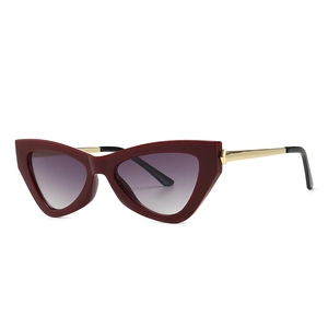 Retro cat-eye sunglasses with dark red matte frames and gradient lenses on a white background