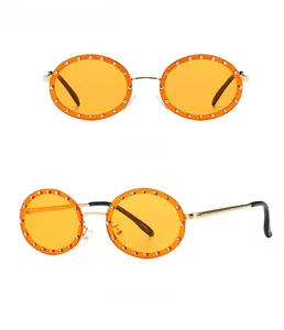 Detailed front and side views of gold oval sunglasses with sparkling rhinestones
