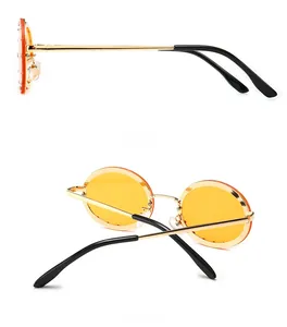 Detailed side and back views of round gold metal sunglasses with yellow lenses