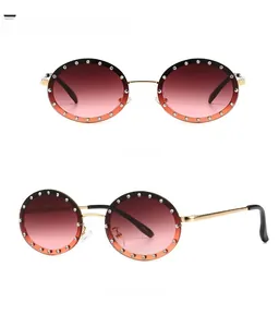 Detailed front and side view of round sunglasses with gradient lenses and rhinestone trim