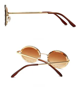 Side and back views of round gold metal sunglasses with brown gradient lenses