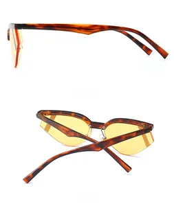 Dettagli laterali e posteriori di occhiali da sole cat-eye vintage con lenti gialle
