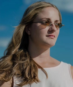 Detail of vintage round steampunk sunglasses with gold metal frame and dark brown lenses