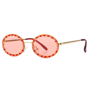 Fashionable round sunglasses with orange lenses and red crystal embellishments