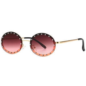 Chic round rhinestone sunglasses with gradient lenses and gold metal frame shown at angle