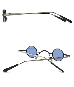 Detail view of retro small round steampunk sunglasses with bronze metal frame and blue lenses