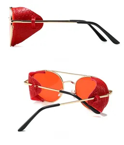 Steampunk sunglasses with red lenses, gold metal frames and crocodile texture side shields