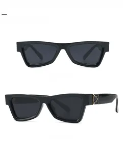 Front and 45-degree side view of black vintage cat-eye sunglasses with gold metal hinges