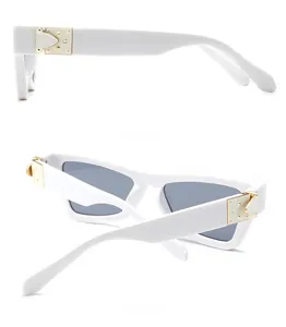Detail of white square sunglasses with gold metal hinges and dark grey lenses