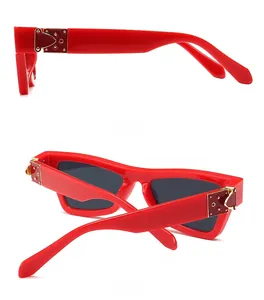 Detailed side and back views of red cat eye sunglasses with gold metallic hinge accents