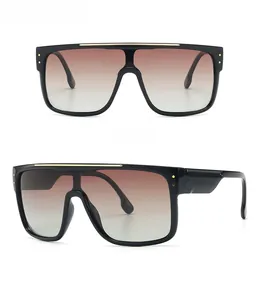 Detail view of oversized flat top sunglasses with gradient lenses and gold metallic accents