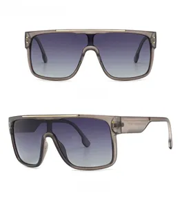 Detailed front and side views of oversized gray sunglasses with gradient lenses and gold trim