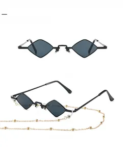 Detailed view of black metal diamond sunglasses with gold beaded chain and dark lenses