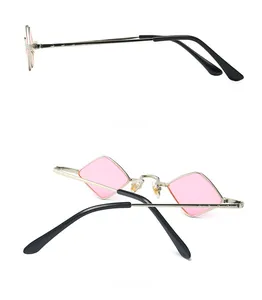 Detail view of pink diamond-shaped sunglasses with a thin silver metal frame