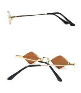 Detail view of gold metal temples and brown lenses on retro geometric sunglasses