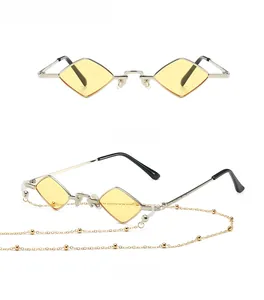 Detail of diamond-shaped silver sunglasses with yellow lenses and golden beaded chain