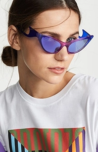 Detail of purple wavy flame frame cat eye sunglasses with blue lenses on model