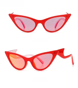 Detail of red cat-eye sunglasses with unique wavy temples and translucent lenses