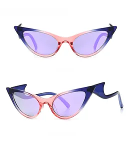 Close-up of cat-eye sunglasses with gradient frames and unique wavy temple design
