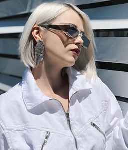 Fashion long silver fringe earrings with rhinestones worn by a model in outdoor lighting