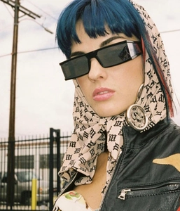 Street style beige headscarf with gothic lettering and black rectangular sunglasses