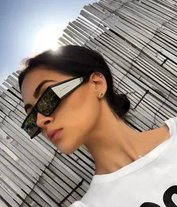 Fashionable outdoor portrait of square black sunglasses with white side temples