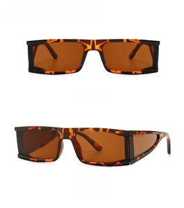 Detail showing square tortoiseshell sunglasses with brown lenses and geometric cut-outs