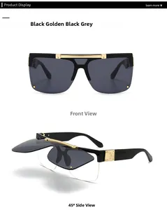 Detail of modern oversized flip-up sunglasses with black and gold frames and grey lenses