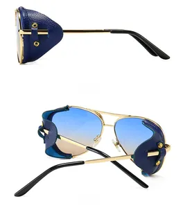 Detail of vintage steampunk sunglasses featuring gold frames and blue leather side shields