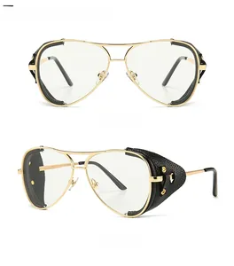 Close-up of gold metal aviator frames with black side shields and clear lenses