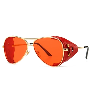 Retro aviator sunglasses with gold frame and red leather side shields shown at angle